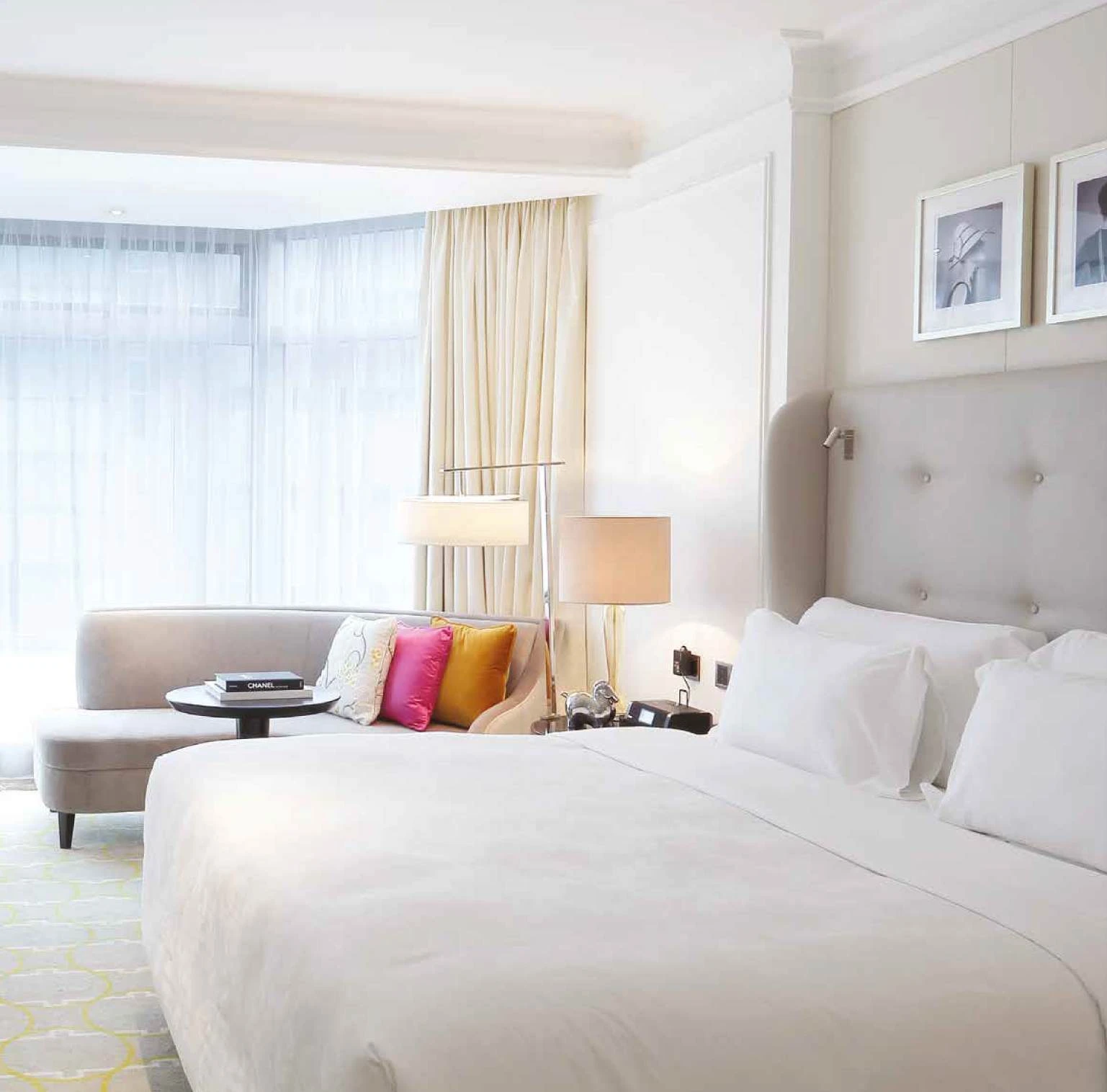Upholstered headboard, bedside lamp and guestroom seating