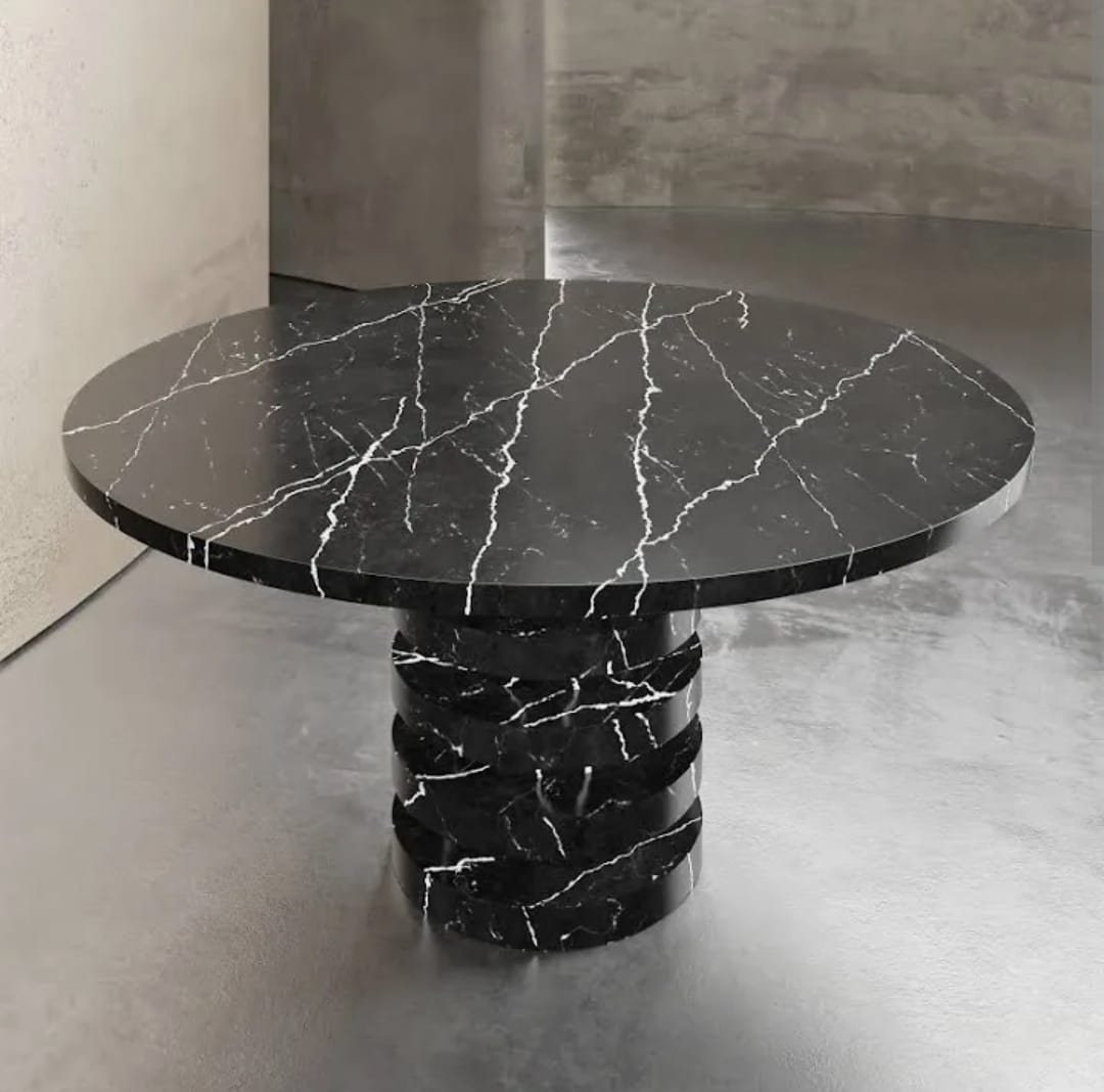 Black stone table with stacked pedestal (Source photo · piece / installation)