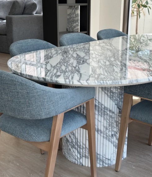 Reference image of a veined marble dining table top and fluted pedestal