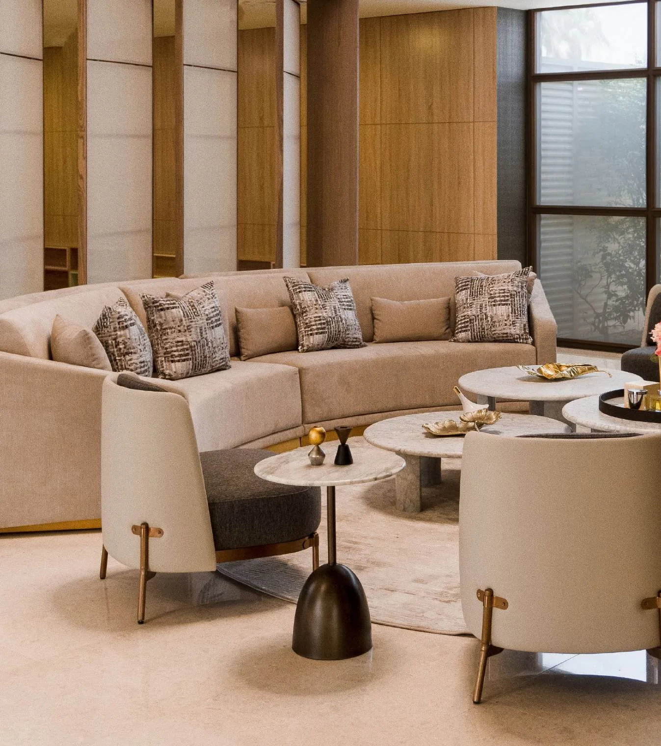 Commercial lounge with curved banquette, occasional chairs and tables