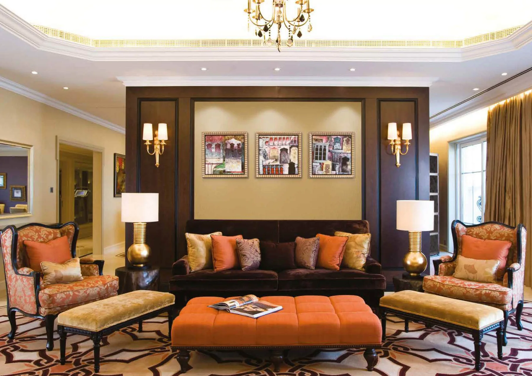Classic hotel lounge with sofa, armchairs, ottoman and table lamps