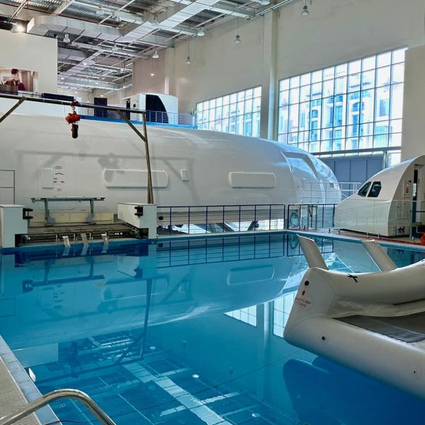 Water survival training pool with aircraft training equipment