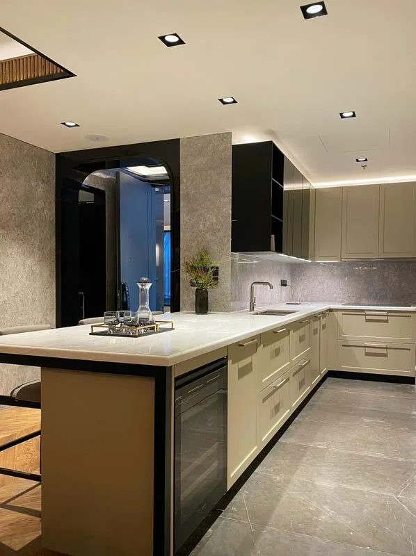 Fitted kitchen with stone worktop, island and full-height cabinetry