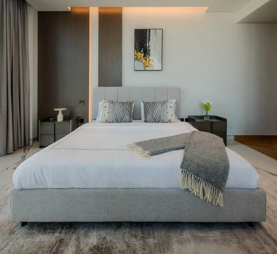 Upholstered bed with bedside tables and coordinated lamps