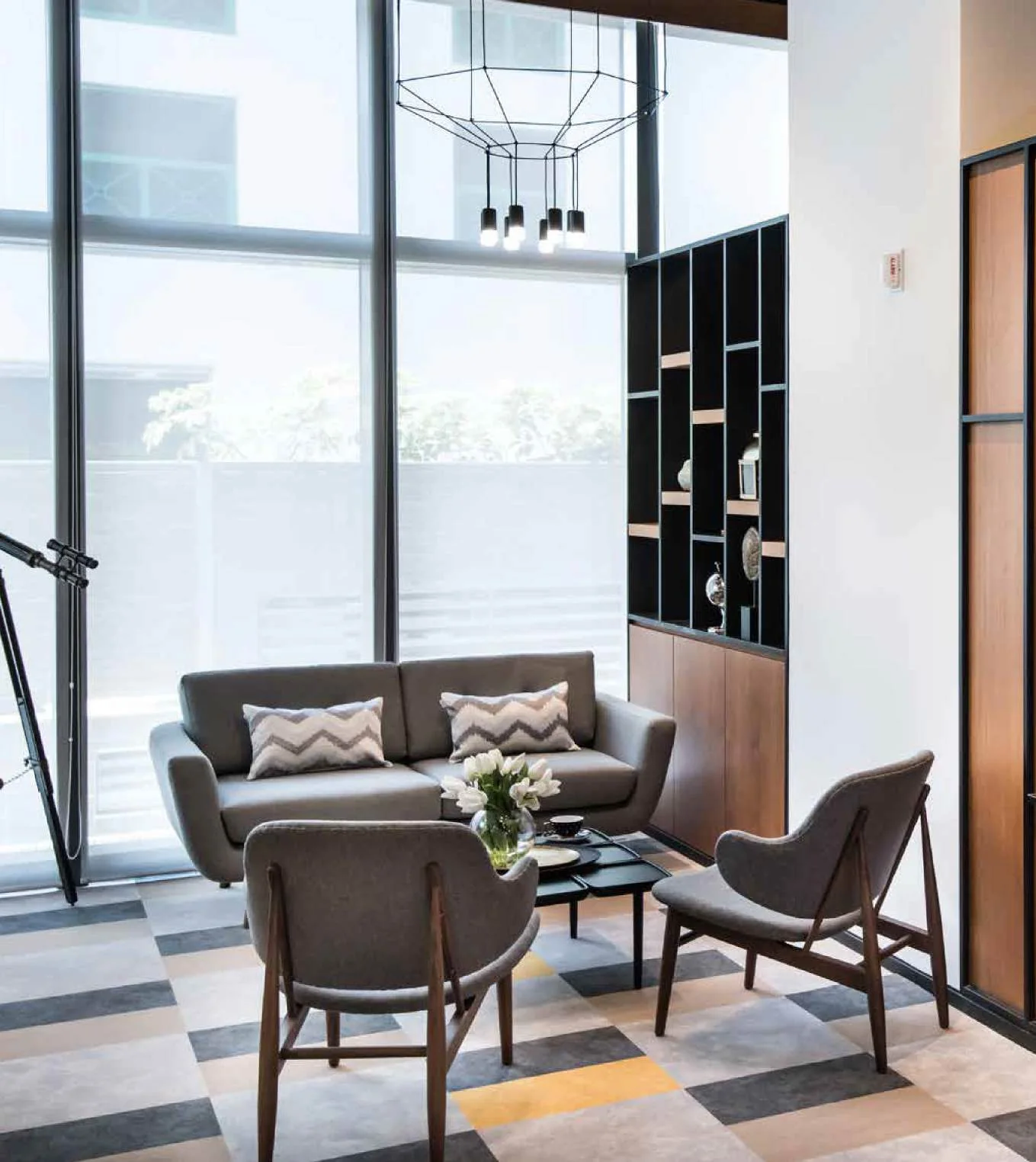 Workplace meeting area with lounge chairs beside a glazed wall