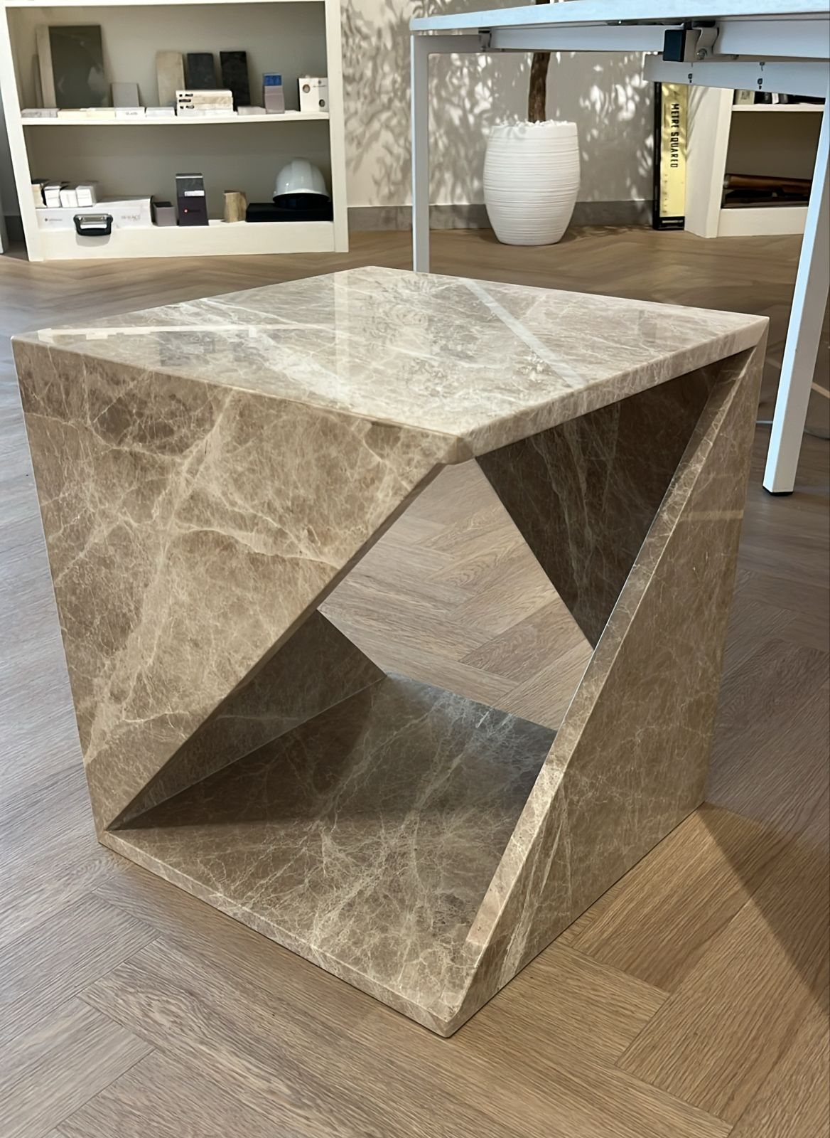Folded side table in grey-brown stone (Source photo · piece / installation)