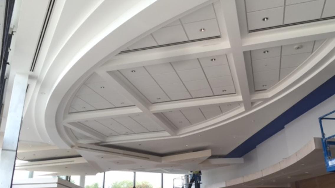 Coffered curved ceiling during installation with formed structure and lighting positions