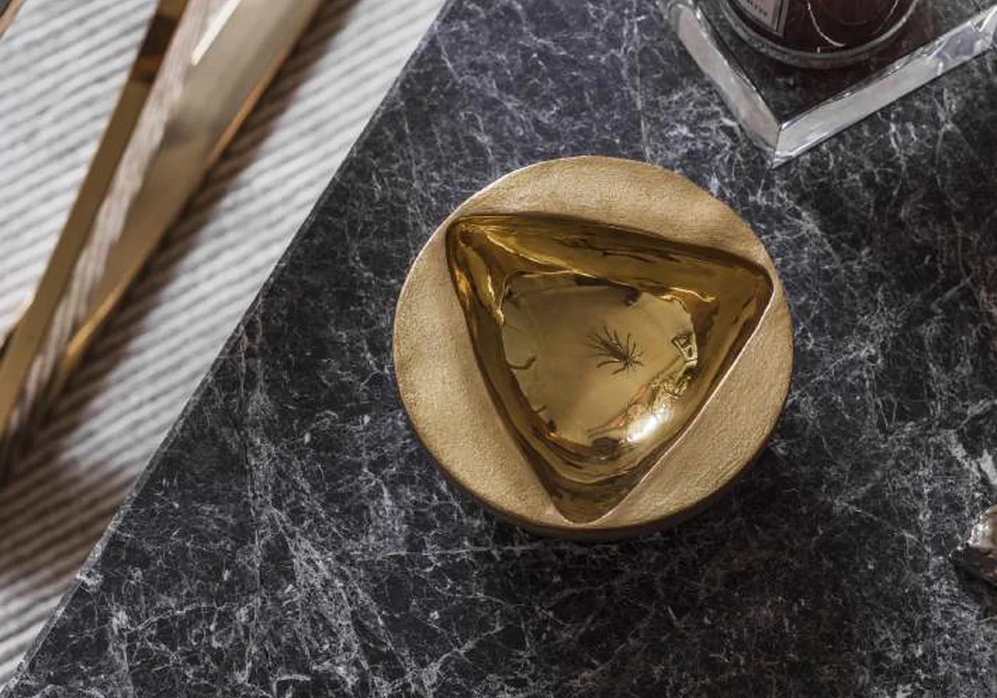 Sculptural brass bowl on a dark stone surface