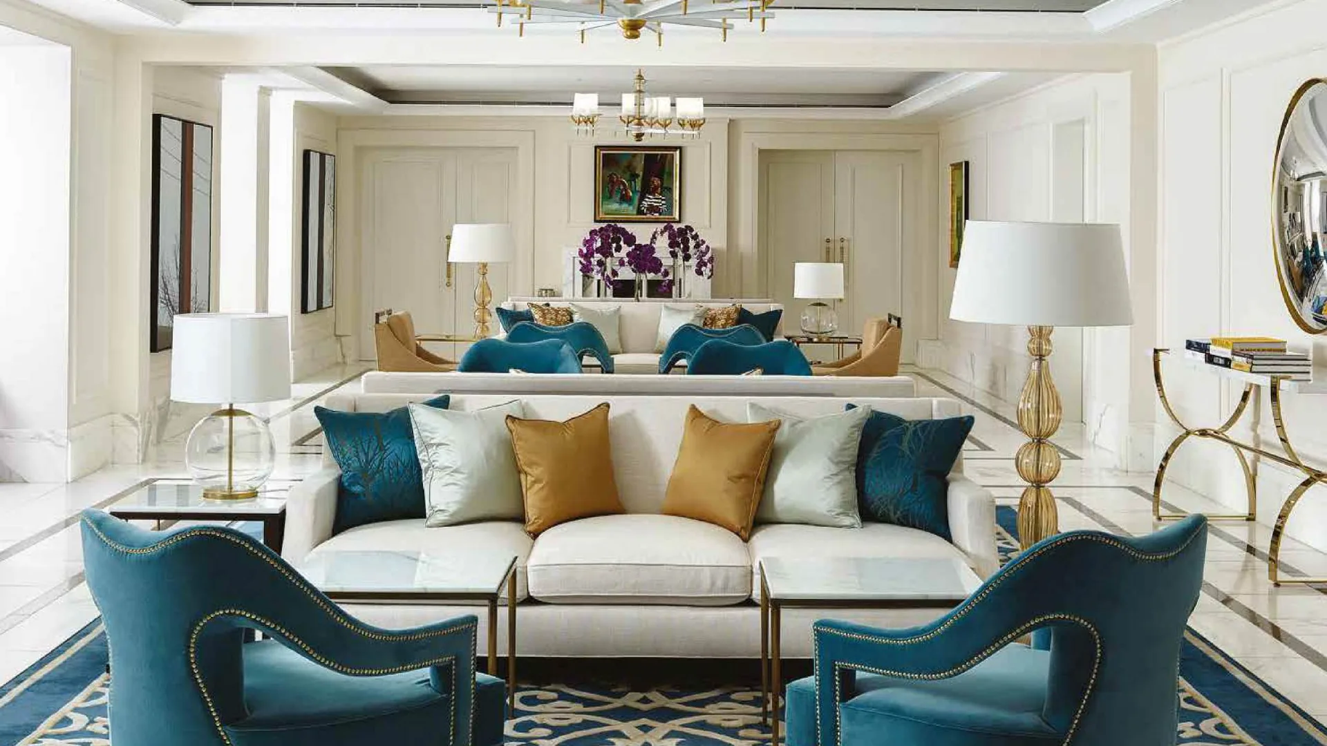 Complete furnished interior with teal lounge chairs, white sofas and coordinated lighting