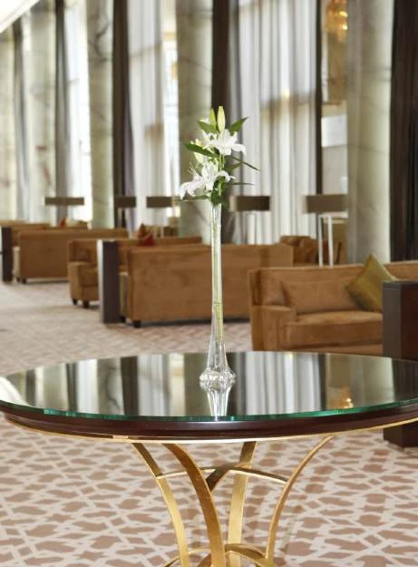 Lounge seating arranged around glass-topped tables