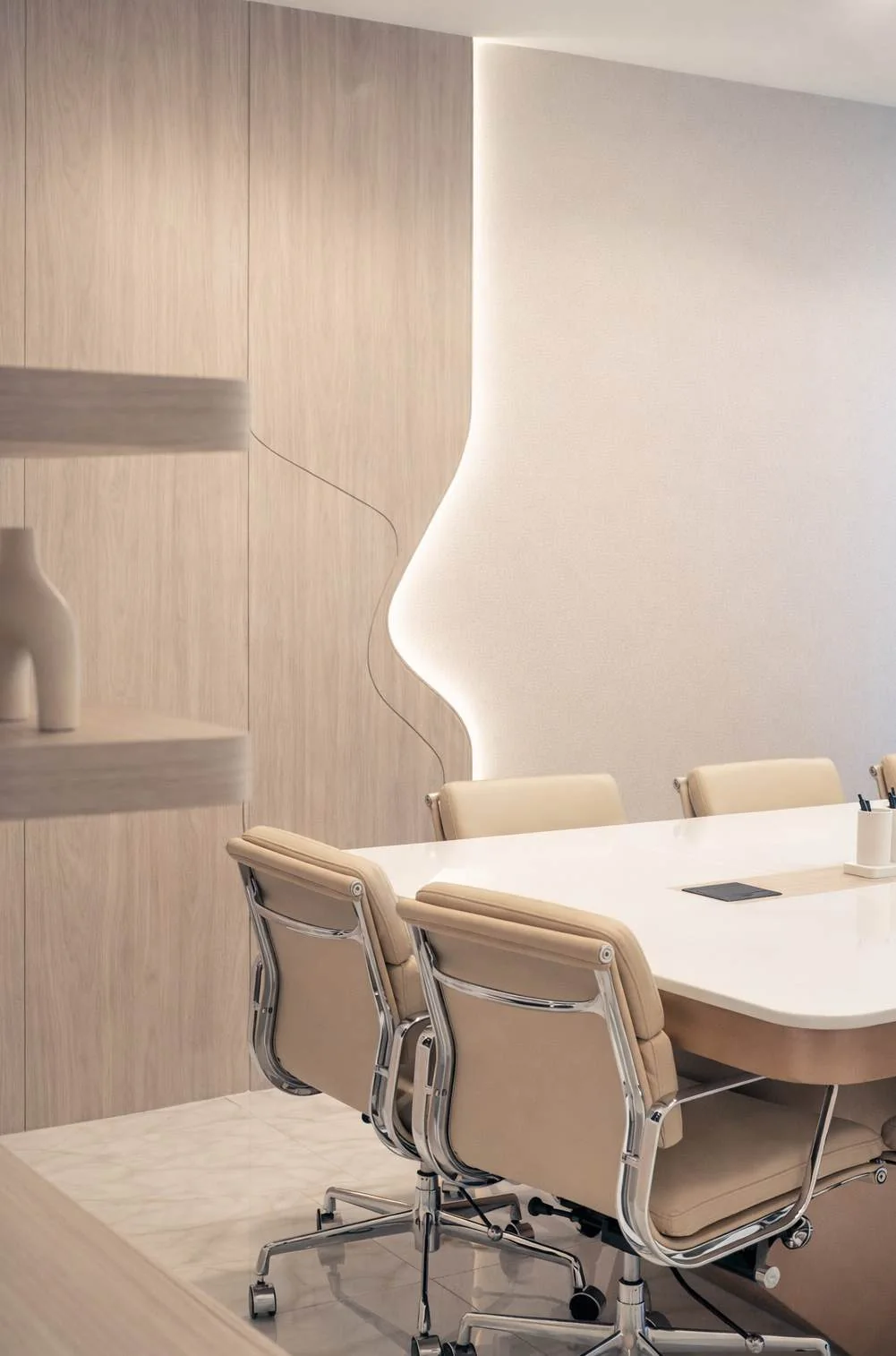 Timber meeting-room joinery with integrated lighting and shelving
