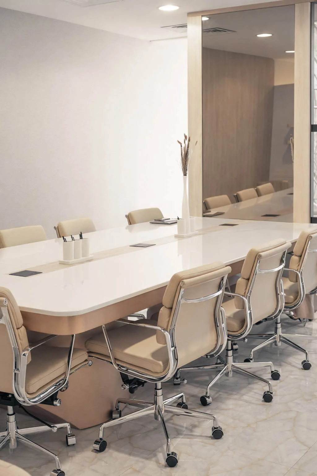 Boardroom with a long meeting table, task chairs and coordinated lighting