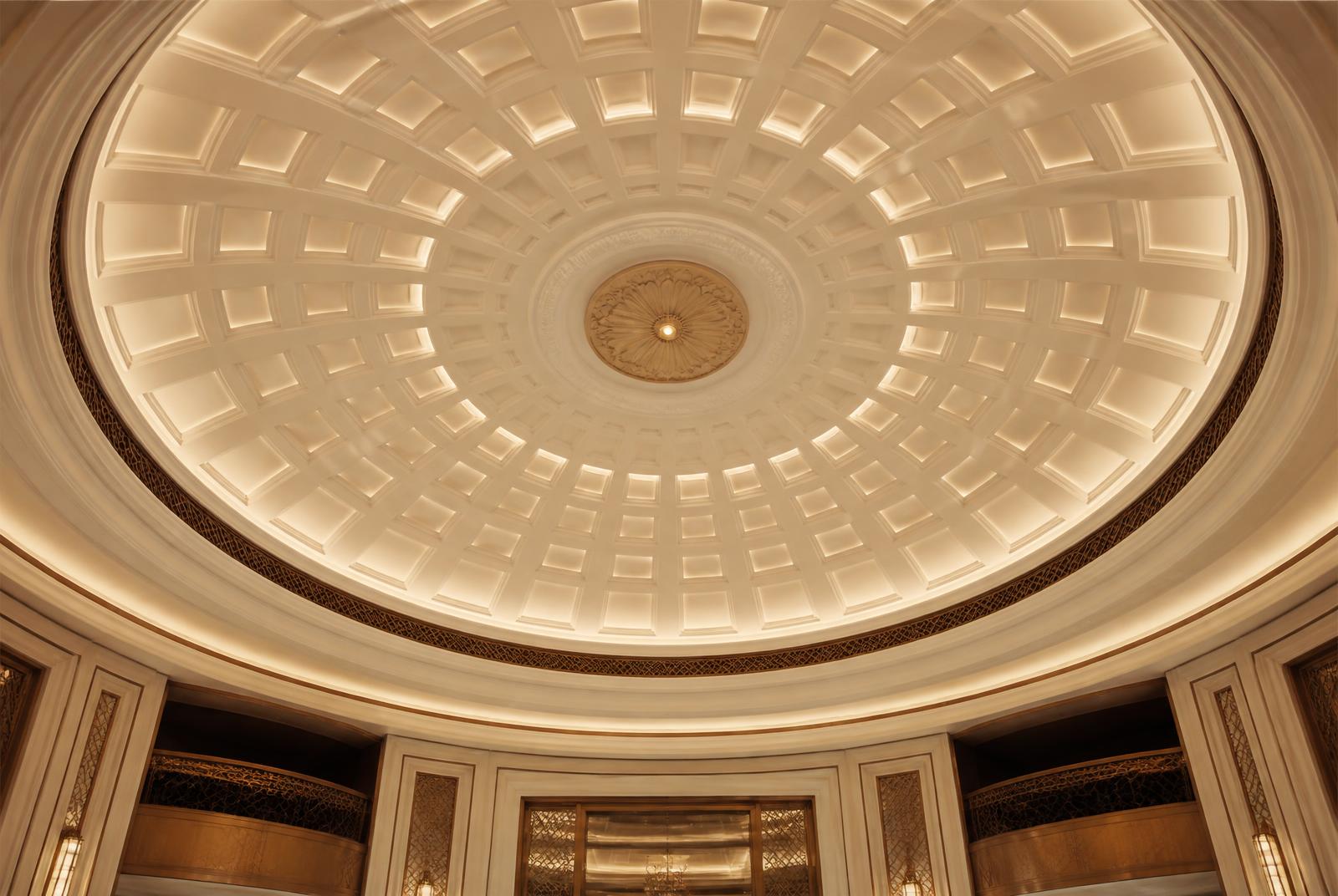 Coffered dome ceiling in cast decorative plaster above a hotel lobby
