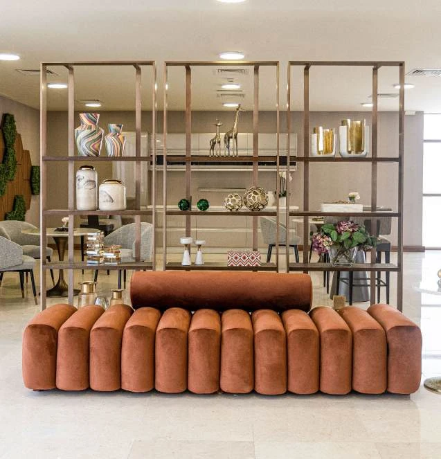 Open display shelving beside upholstered seating