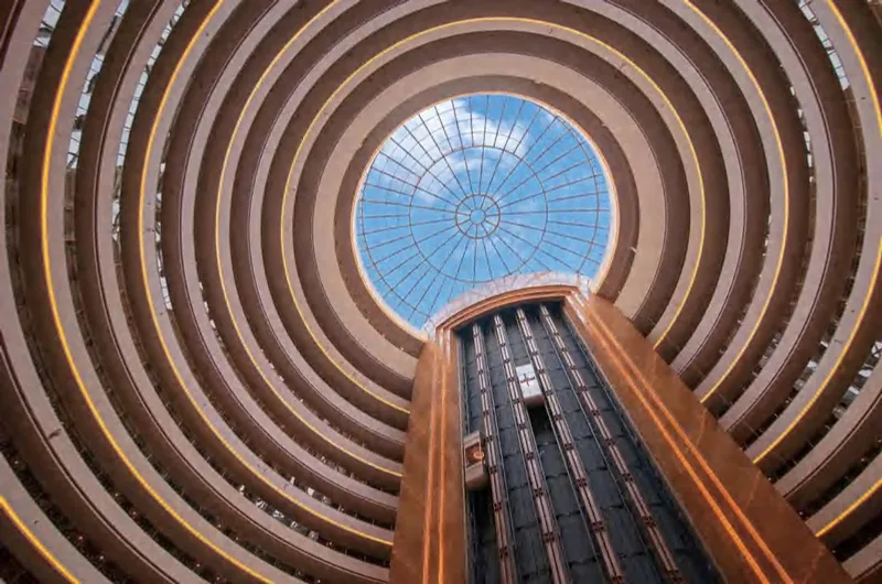 Curved timber-lined atrium rising to a circular rooflight