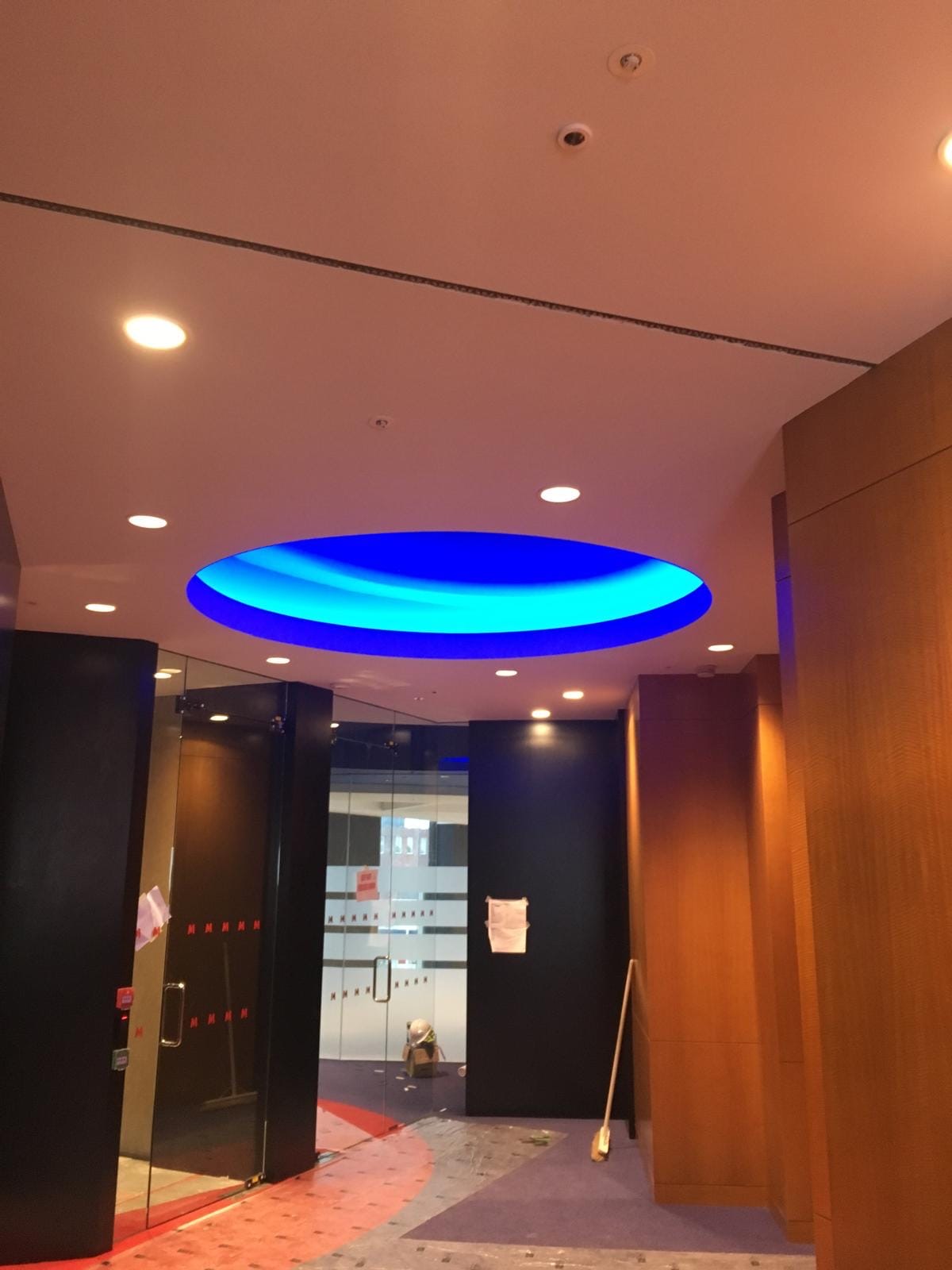 Completed corridor ceiling with an illuminated circular feature