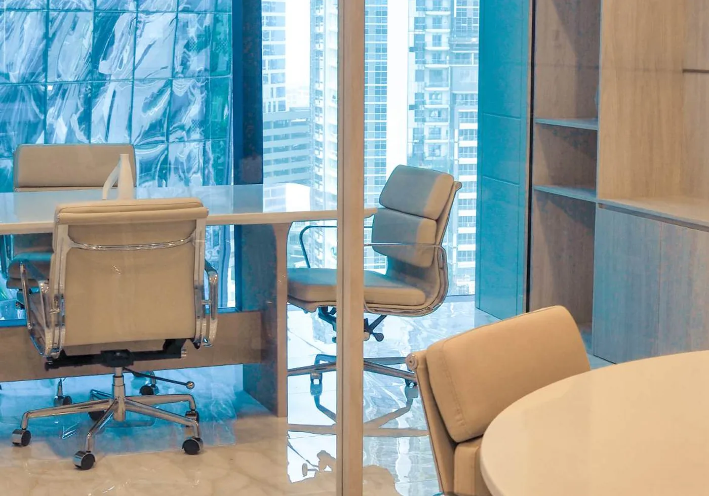 Workplace meeting rooms with upholstered task chairs and city views