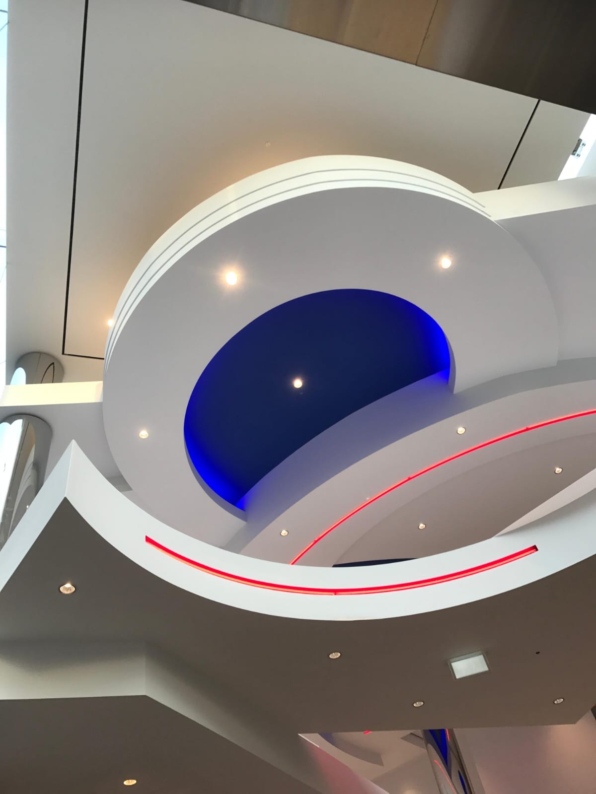 Completed atrium ceiling with layered curved forms and integrated lighting