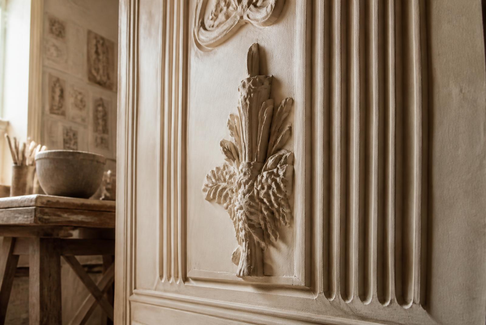 Hand-carved decorative relief panel in fine plaster, raking daylight