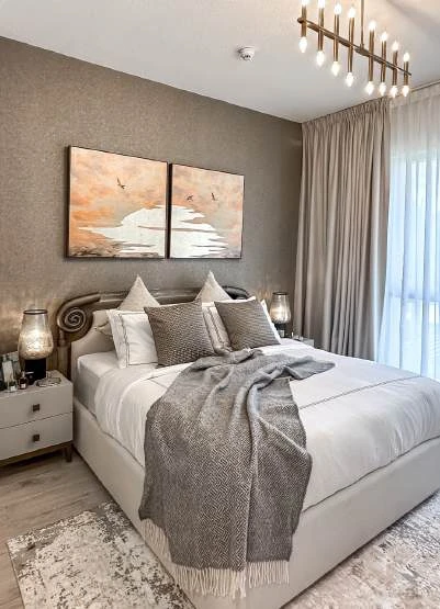 Upholstered bed with bedside tables and coordinated lighting