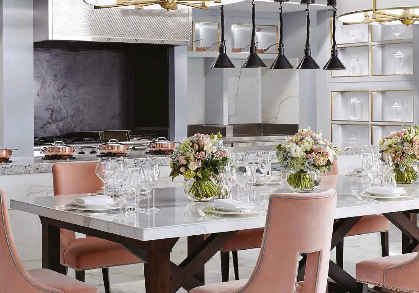 Dining setting with blush upholstered chairs and pendant lighting