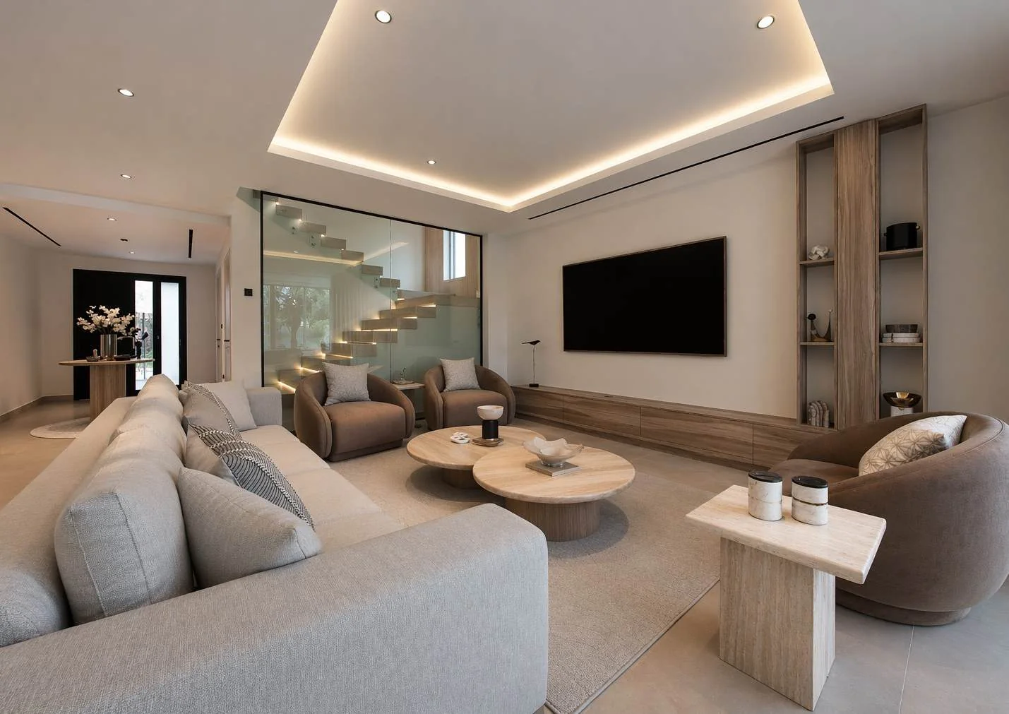 Warm living room with sofa, lounge chairs, tables and layered lighting
