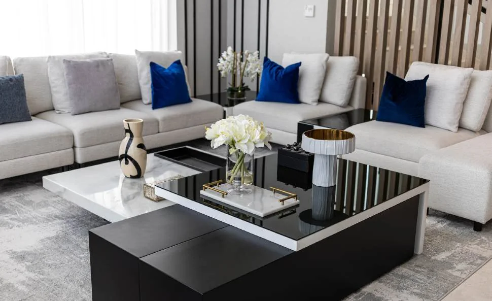 Modern living room with sectional sofa, occasional chairs and timber media wall