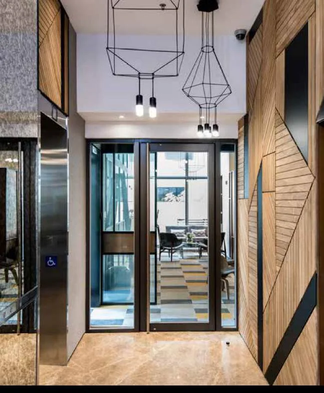 Meeting chairs beside a curved illuminated architectural wall detail