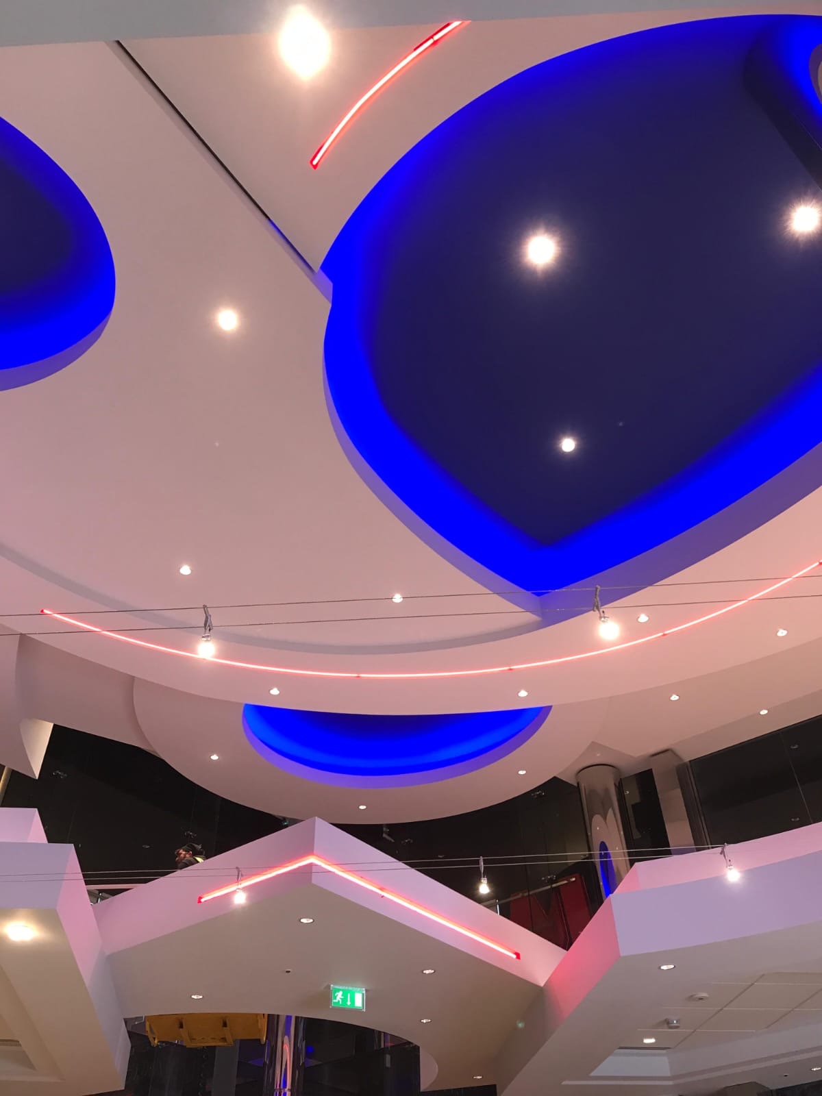 Feature ceiling with recessed circular forms, spotlights and linear lighting