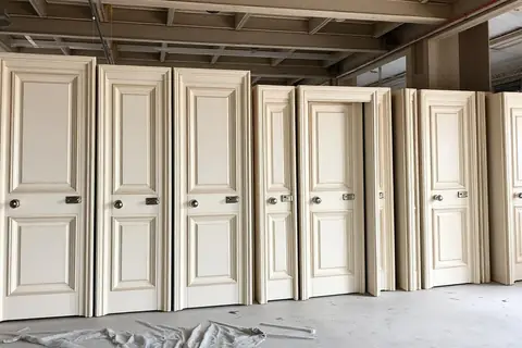 Finished doorsets standing on the floor plate ahead of second fix