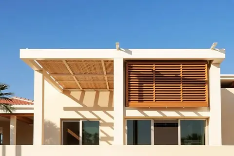Composite-clad pergola and louvre screen over a resort terrace