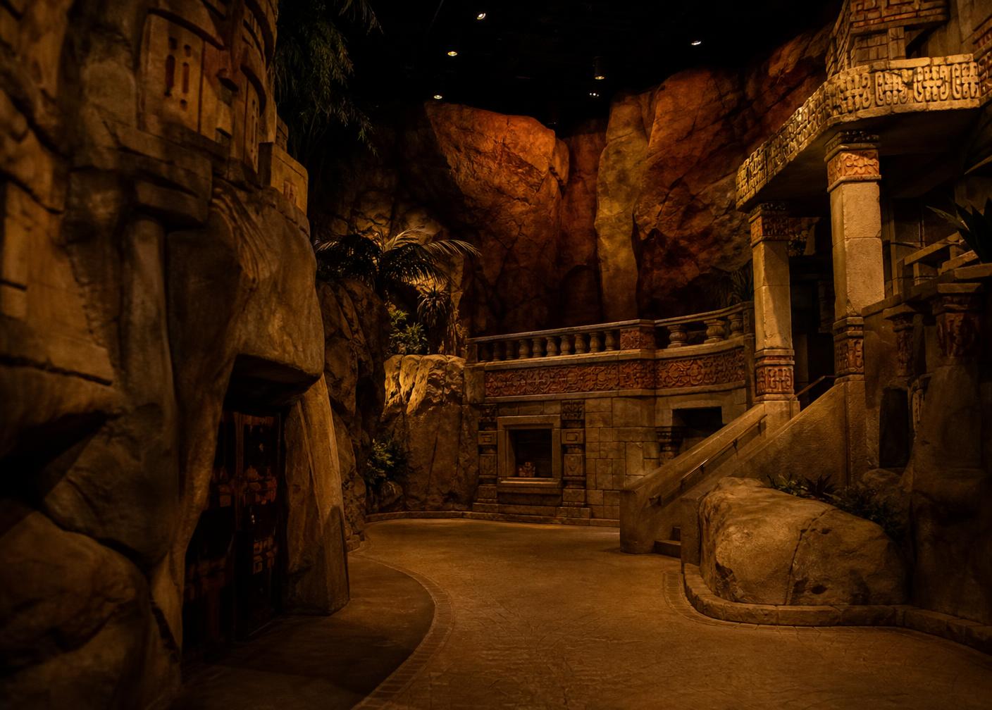 Themed attraction interior with sculpted composite rockwork and hand-painted scenic finishes