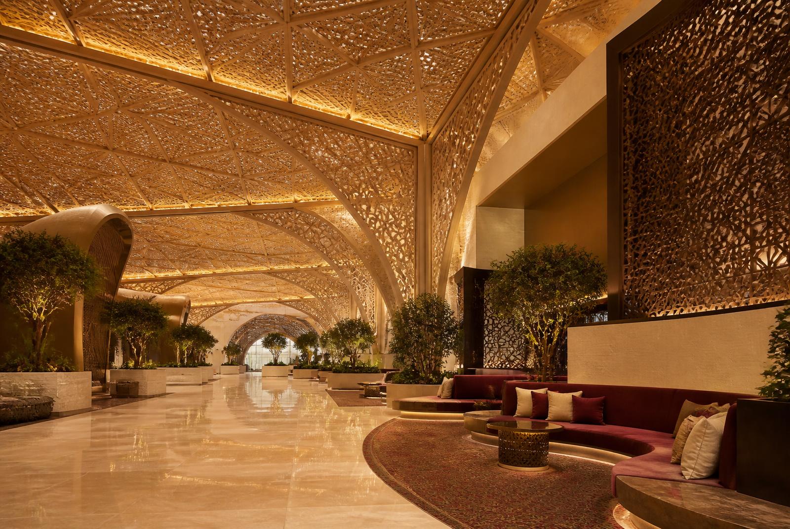 Airport terminal interior with vaulted latticed ceiling, stone floor and burgundy seating